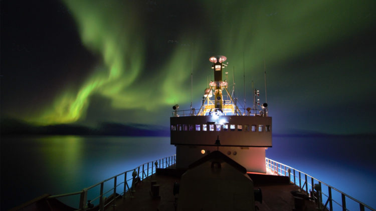 Northern-lights-and-the-research-vessel-Paamiut-(GINR),-West-Greenland